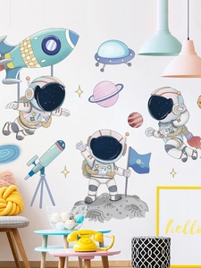 Detail of macaron-colored cartoon astronaut wall stickers set on white bedroom wall