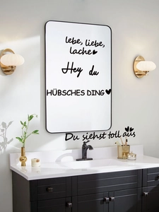 Detail of German inspirational quotes wall stickers on a modern bathroom mirror