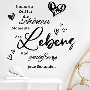 Inspirational German wall decal with hearts on white wall in modern living room