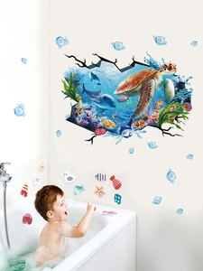 Toddler playing with 3D ocean wall stickers featuring sea turtles and colorful bubbles
