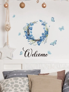 Dettaglio dell'adesivo murale con ghirlanda floreale blu, farfalle e scritta Welcome decor