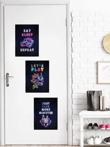 Three-piece neon gaming wall stickers featuring game controllers on a modern white door
