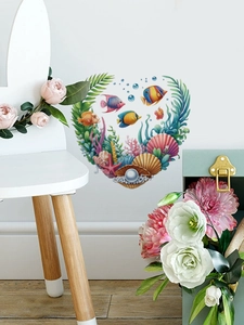 Detail of self-adhesive ocean fish wall stickers in heart shape for home decoration