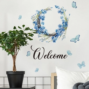 Adesivo murale ghirlanda di fiori blu con farfalle e scritta Welcome decorativa