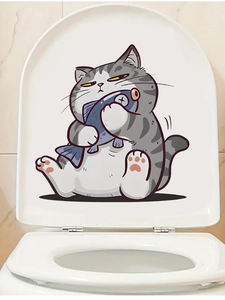 Detail of cute grey cat and blue fish PVC self-adhesive decal on a white toilet lid