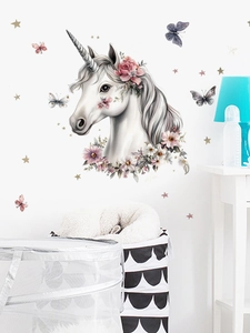 Detail of cute cartoon unicorn wall sticker with floral crown and stars for nursery decor