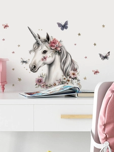 Detail of cartoon unicorn wall decals with pink floral crown and stars for kids' rooms
