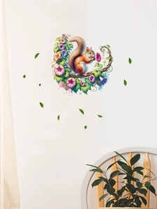 Detailed view of squirrel wall sticker on white wall with morning glory floral design