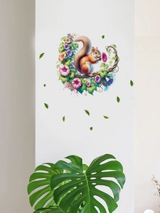 Detail of cartoon squirrel and morning glory PVC wall decal on white living room wall
