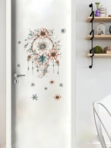 Detail view of boho floral dreamcatcher wall decals on a white door in a warm cozy room