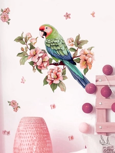 Detail of colorful parrot and flower wall stickers on a cozy bedroom wall background