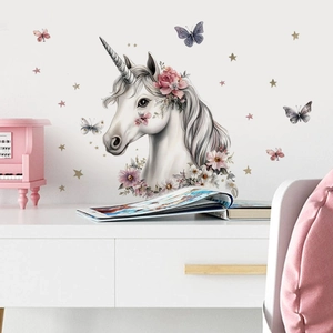 Cartoon unicorn wall decal with pink flower headpiece and gold stars for nursery decor