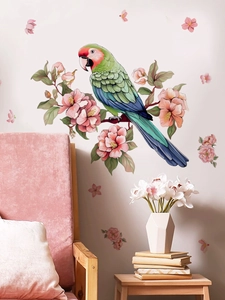 Close-up of a green parrot and pink flower wall decal in a cozy bedroom setting