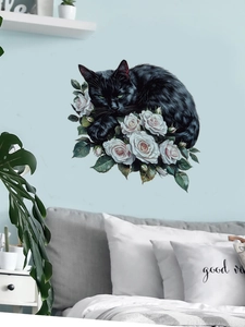 Bedroom wall decor featuring a black cat with green eyes resting among white roses