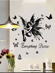 Detail of fairy and butterfly wall stickers with Everything Better quote on a dining room wall
