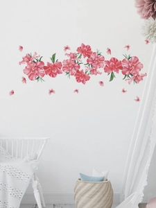 Detail of pink flower wall stickers applied on white wall for a cozy home atmosphere