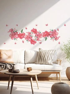 Detail of pink floral wall stickers with butterflies in a modern living room setting