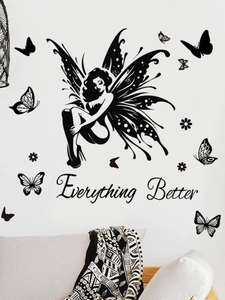 Macro detail of black butterfly fairy wall sticker with Everything Better quote on a white wall