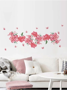 Close-up of pink flower wall decals with butterflies in a cozy living room scene