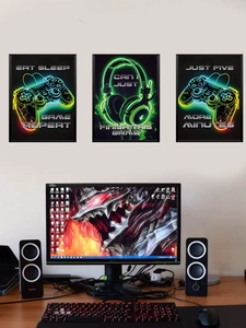 Three-piece neon gaming wall art set featuring controller and eat sleep game repeat text