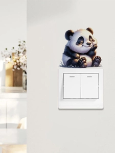 Detailed close-up of a cute cartoon panda wall sticker placed above a light switch
