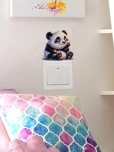 Detail shot of a cute 3D panda wall sticker above a light switch in a cozy living room