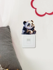 Close-up of a cute panda wall sticker perfectly framing a home light switch panel