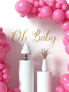 Detail of pink balloon arch kit with Oh Baby gold sign for baby shower party decoration