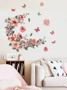 Detail of pink floral crescent moon wall stickers with colorful butterflies on a beige wall