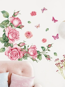 Detail of pink rose wall decals with watercolor butterflies over a soft pink sofa
