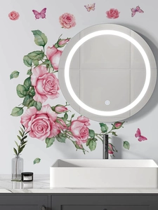 Detail of pink rose and butterfly wall stickers surrounding a modern LED mirror