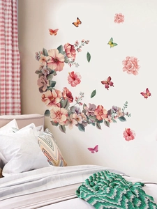 Detailed pink floral and butterfly wall stickers applied on a cozy bedroom wall