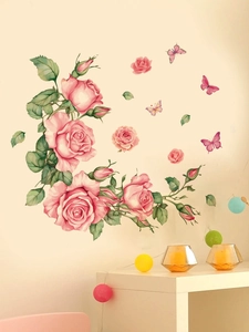 Detail showing pink watercolor rose vine and butterfly wall stickers on a home wall