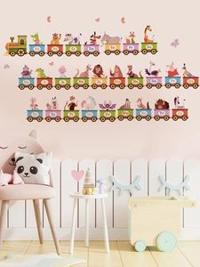 Detailed scene of cartoon animal alphabet train wall stickers in a cozy pink kid bedroom