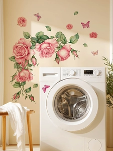 Detailed view of pink rose and butterfly wall stickers applied on smooth home surfaces