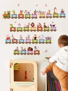 Detail view of animal alphabet train wall decals applied to a white nursery bedroom wall