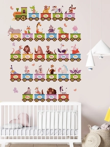 Detailed close-up of 26 alphabet animal train wall stickers in a cozy nursery bedroom