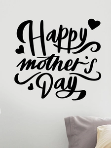 Detail of Happy Mother's Day black wall sticker with hearts on a white bedroom wall