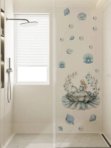 Detail of blue mermaid and pearl shell wall decals applied on bathroom glass door