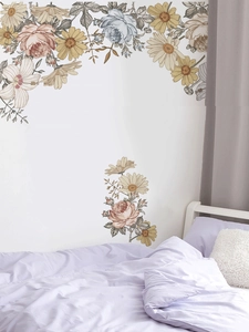 Detail view of vintage hand-painted floral wall decals with roses and daisies in bedroom