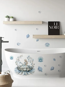 Detail showing mermaid and pearl shell wall stickers on a bathtub in a bathroom setting