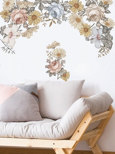 Detailed view of vintage floral PVC wall stickers on white wall above a wooden sofa