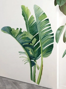 Détail de stickers muraux feuilles de palmier aquarelle sur un mur blanc minimaliste
