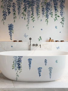 Detail of blue wisteria and butterfly PVC wall decals applied to a modern bathroom bathtub
