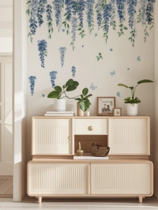 Detailed view of blue watercolor wisteria vine and butterfly wall stickers on a neutral wall