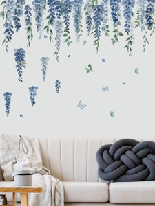 Detailed view of blue wisteria flower wall stickers with butterfly accents on living room wall