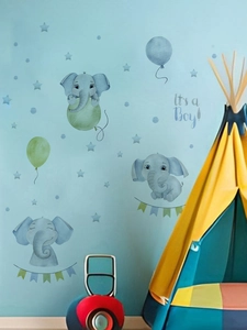 Detail of blue cartoon elephant wall stickers with It's a Boy text for nursery decor