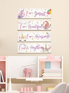 Detail of four unicorn wooden wall plaques with inspirational phrases for kids' rooms