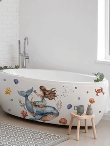 Detail of mermaid and whale wall decals on a white bathtub in a modern bathroom setting