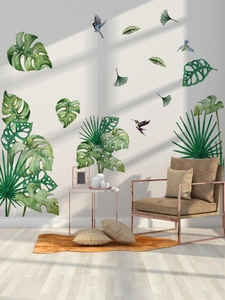 Detail of tropical monstera leaf wall decals with bird accents for home decoration
